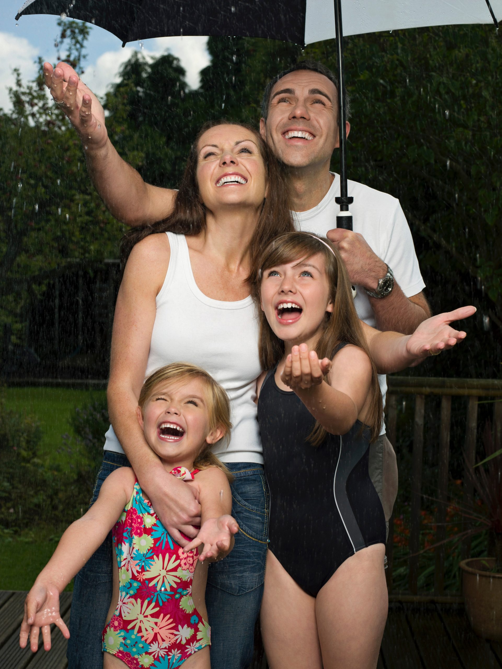 A family under an umbrella in the rain
