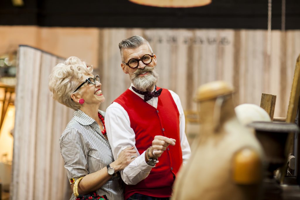 Quirky vintage couple shopping in antiques emporium