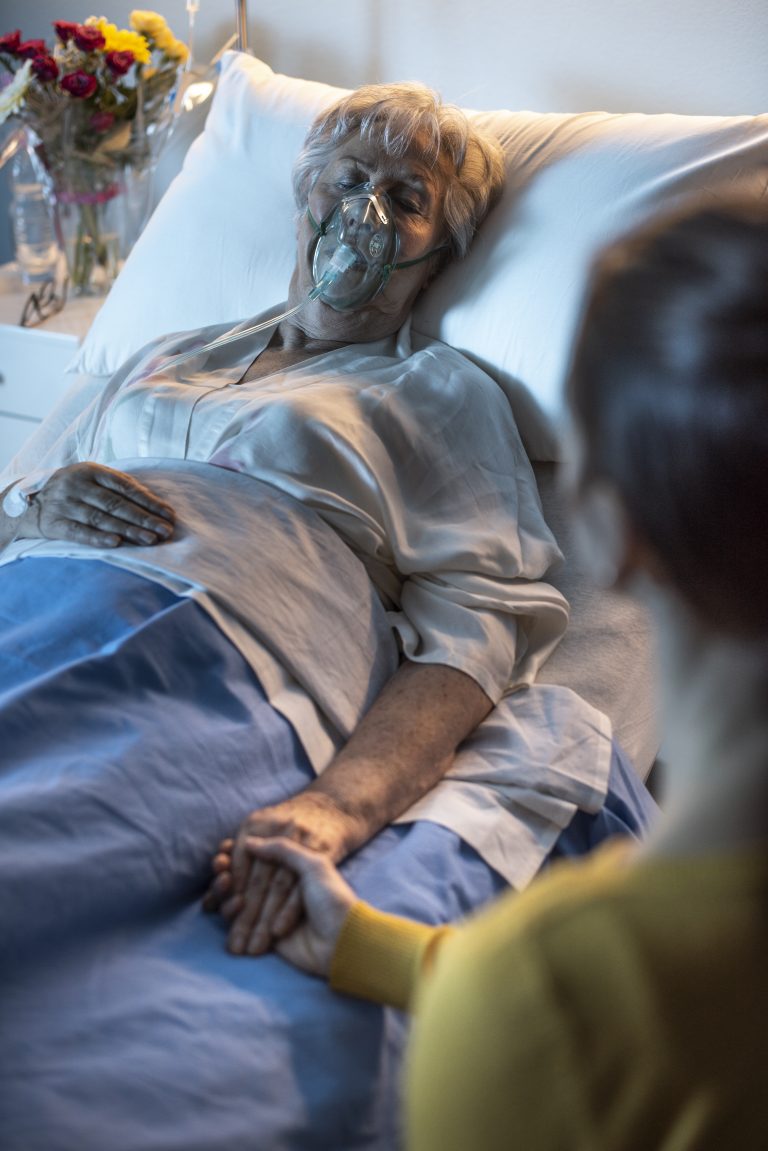 Woman assisting her senior mother at the hospital